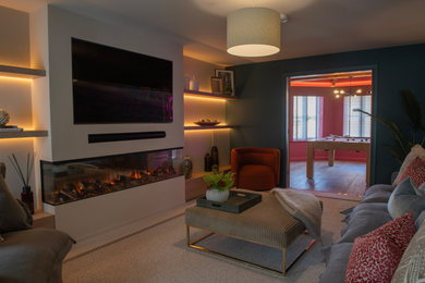 This is an example of a medium sized contemporary open plan living room in Other with multi-coloured walls, carpet, a two-sided fireplace, a plastered fireplace surround, a wall mounted tv and beige floors.