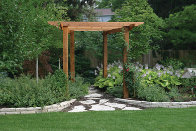 Elegant backyard stone patio photo in Chicago