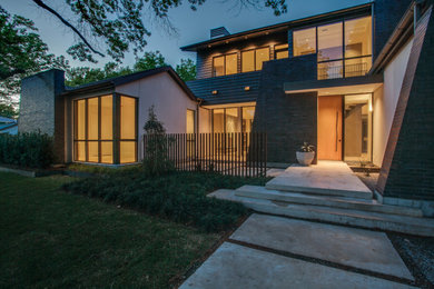 Huge minimalist multicolored two-story mixed siding exterior home photo in Dallas with a mixed material roof