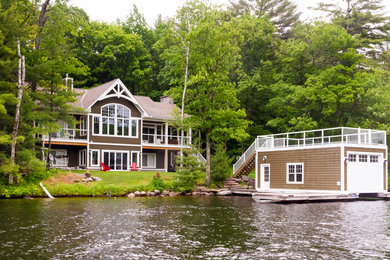 Inspiration for a large timeless brown two-story wood exterior home remodel in Toronto with a shingle roof