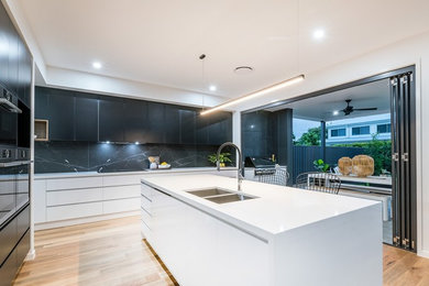 This is an example of a mid-sized modern kitchen in Brisbane.