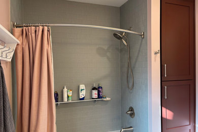 Example of a mid-sized transitional master gray tile and ceramic tile vinyl floor, gray floor and single-sink bathroom design in Other with shaker cabinets, red cabinets, a one-piece toilet, pink walls, an undermount sink, quartzite countertops, gray countertops and a freestanding vanity