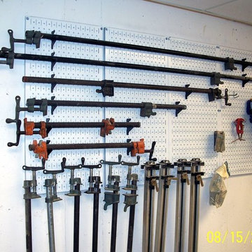 White metal pegboard by Wall Control being used to hold some heavy tools. | Indu
