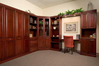 Example of a mid-sized classic built-in desk carpeted and beige floor study room design in Charleston with beige walls