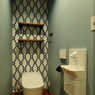 東京都下のアジアンスタイルのおしゃれなトイレ・洗面所 (壁付け型シンク、茶色い床、モノトーンのタイル、緑の壁、濃色無垢フローリング) の写真