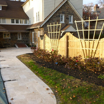 A couple of small traditional trellises to support red roses climbing up out of