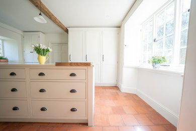 Medium sized traditional kitchen/diner in Oxfordshire with shaker cabinets, white cabinets, an island and white worktops.