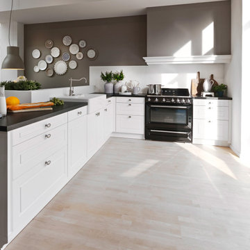 White luxury German kitchen with Island by Kudos Interior Designs