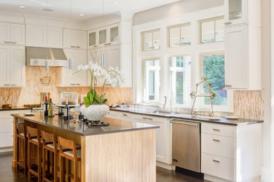 Eat-in kitchen - large traditional u-shaped dark wood floor and brown floor eat-in kitchen idea in Los Angeles with an undermount sink, multicolored backsplash, mosaic tile backsplash, stainless steel appliances, an island, flat-panel cabinets, white cabinets, solid surface countertops and gray countertops
