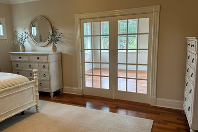 Example of a large arts and crafts master medium tone wood floor bedroom design in St Louis with beige walls