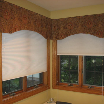 Corner bathroom window with arched cornice boards