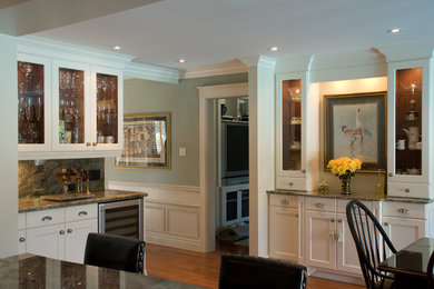 Example of a large classic galley medium tone wood floor eat-in kitchen design in Toronto with an undermount sink, shaker cabinets, white cabinets, granite countertops, green backsplash, stone slab backsplash, stainless steel appliances and an island
