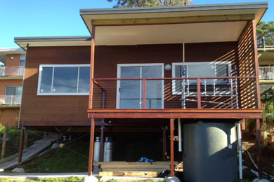 Photo of a traditional brown exterior in Central Coast with a flat roof.