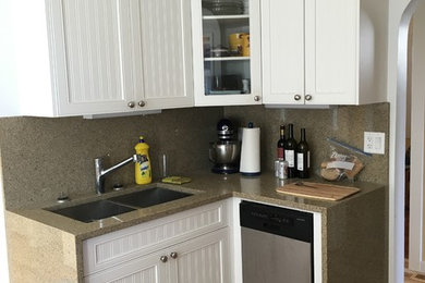 Mid-sized trendy l-shaped light wood floor kitchen pantry photo in Vancouver with an undermount sink, shaker cabinets, white cabinets, wood countertops, multicolored backsplash, stone tile backsplash, stainless steel appliances and a peninsula