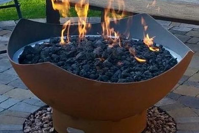 Inspiration for a mid-sized contemporary backyard brick patio remodel in Phoenix with a fire pit and no cover