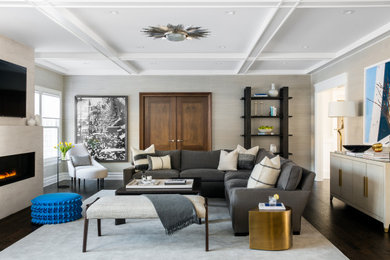 Transitional dark wood floor, brown floor and wallpaper living room photo in New York with beige walls, a stone fireplace, a wall-mounted tv and a ribbon fireplace