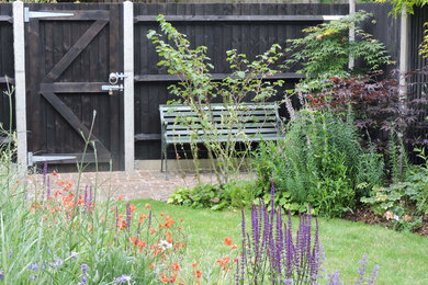 Photo of a contemporary backyard garden in Cambridgeshire with natural stone pavers.