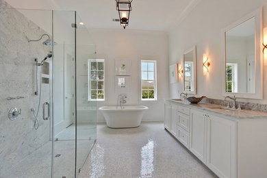 Large contemporary master bathroom in New Orleans with shaker cabinets, white cabinets, a freestanding tub, a corner shower, white walls, mosaic tile floors, an undermount sink, granite benchtops, white floor and a hinged shower door.
