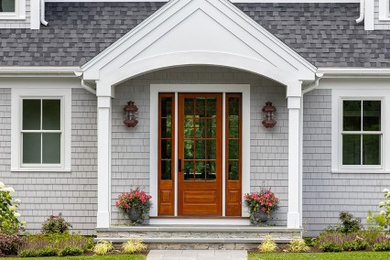 Inspiration for a large coastal entryway remodel in Boston with a medium wood front door