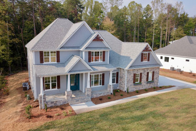 Inspiration for a craftsman gray two-story concrete fiberboard house exterior remodel in Other with a shingle roof