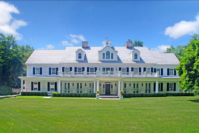 Large elegant white two-story wood exterior home photo in Other
