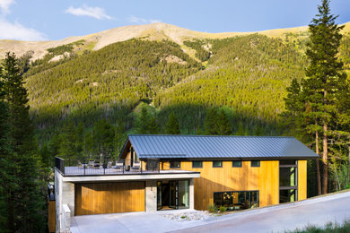 Inspiration for a rustic house exterior remodel in Denver with a metal roof and a black roof