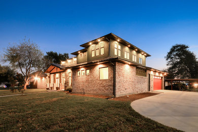 Inspiration for a large transitional green two-story mixed siding exterior home remodel in Houston with a hip roof