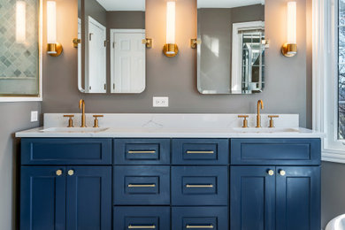 Inspiration for a large timeless master white tile and marble tile marble floor, white floor and double-sink bathroom remodel in Chicago with flat-panel cabinets, blue cabinets, a one-piece toilet, gray walls, a drop-in sink, quartz countertops, a hinged shower door, white countertops, a niche and a freestanding vanity