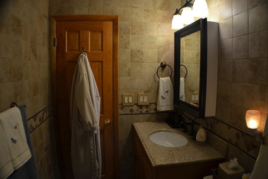 Small elegant master beige tile and porcelain tile porcelain tile bathroom photo in Chicago with recessed-panel cabinets, light wood cabinets, a two-piece toilet, beige walls, an undermount sink and granite countertops