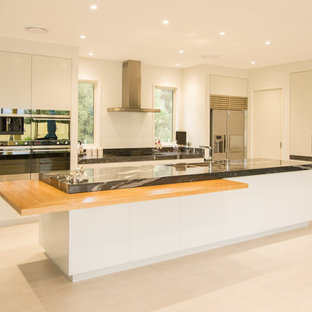 Mid-sized contemporary kitchen pantry designs - Example of a mid-sized trendy galley ceramic floor kitchen pantry design in Napier-Hastings with a double-bowl sink, white cabinets, granite countertops, white backsplash, glass sheet backsplash, stainless steel appliances and an island