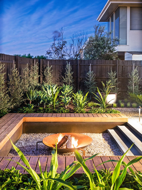 Contemporary Landscape Inspiration for a mid-sized contemporary full sun backyard landscape in Melbourne with a fire