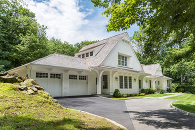 Inspiration for a large timeless white two-story wood exterior home remodel in New York with a shingle roof