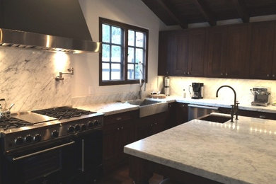 Elegant kitchen photo in San Francisco with marble countertops, stone slab backsplash and an island
