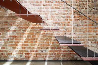 Photo of a mid-sized industrial metal straight staircase in Madrid with open risers.