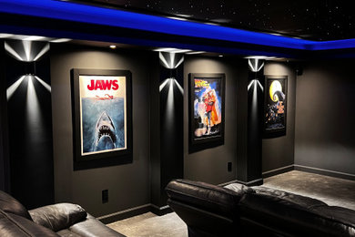 Large minimalist open concept carpeted and black floor home theater photo in DC Metro with black walls