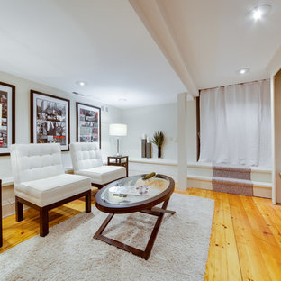 Contemporary fully buried basement in Toronto with white walls, medium hardwood flooring, no fireplace and yellow floors.