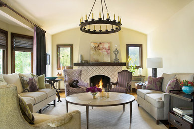Example of a large mountain style open concept medium tone wood floor and beige floor living room design in San Francisco with beige walls, a standard fireplace, a tile fireplace and no tv