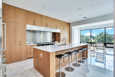 Large trendy l-shaped marble floor and white floor eat-in kitchen photo in Tampa with an undermount sink, flat-panel cabinets, light wood cabinets, quartzite countertops, stainless steel appliances, an island and white countertops