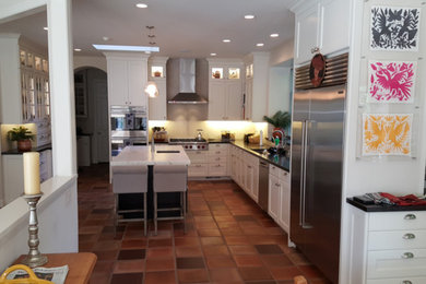 Inspiration for a large transitional u-shaped terra-cotta tile kitchen remodel in San Francisco with an undermount sink, shaker cabinets, white cabinets, quartzite countertops, stainless steel appliances and an island