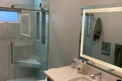 Inspiration for a contemporary master ceramic tile, gray floor and single-sink bathroom remodel in Detroit with shaker cabinets, brown cabinets, gray walls, an undermount sink, quartzite countertops, a niche and a freestanding vanity