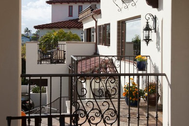Design ideas for a large traditional three-storey stucco white exterior in San Diego.