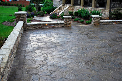 This is an example of a large traditional full sun courtyard concrete paver driveway in Raleigh.