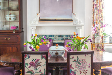 Mid-sized eclectic dark wood floor enclosed dining room photo in DC Metro with a standard fireplace, a tile fireplace and white walls