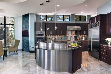 Inspiration for a mid-sized modern l-shaped porcelain tile and beige floor eat-in kitchen remodel in Denver with flat-panel cabinets, dark wood cabinets, granite countertops, gray backsplash, stone tile backsplash, stainless steel appliances and an island
