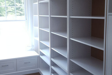 Inspiration for a large contemporary dressing room remodel in New York with open cabinets and light wood cabinets