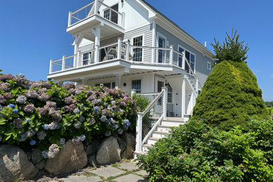 Coastal gray vinyl and board and batten exterior home idea in Providence