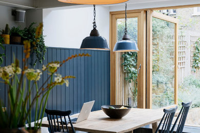 Inspiration for a traditional dining room in London with white walls, concrete floors and grey floor.