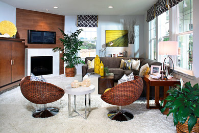 Inspiration for a mid-sized eclectic open concept carpeted family room remodel in Los Angeles with beige walls, a standard fireplace and a wall-mounted tv