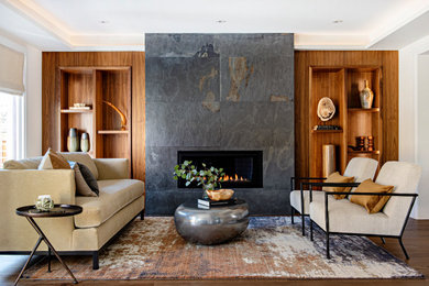 This is an example of a mid-sized contemporary open concept living room in Toronto with white walls, medium hardwood floors, a ribbon fireplace, a stone fireplace surround, wood walls and brown floor.