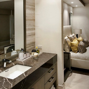 Photo of an expansive transitional guest bedroom in Miami with marble floors and beige floor.